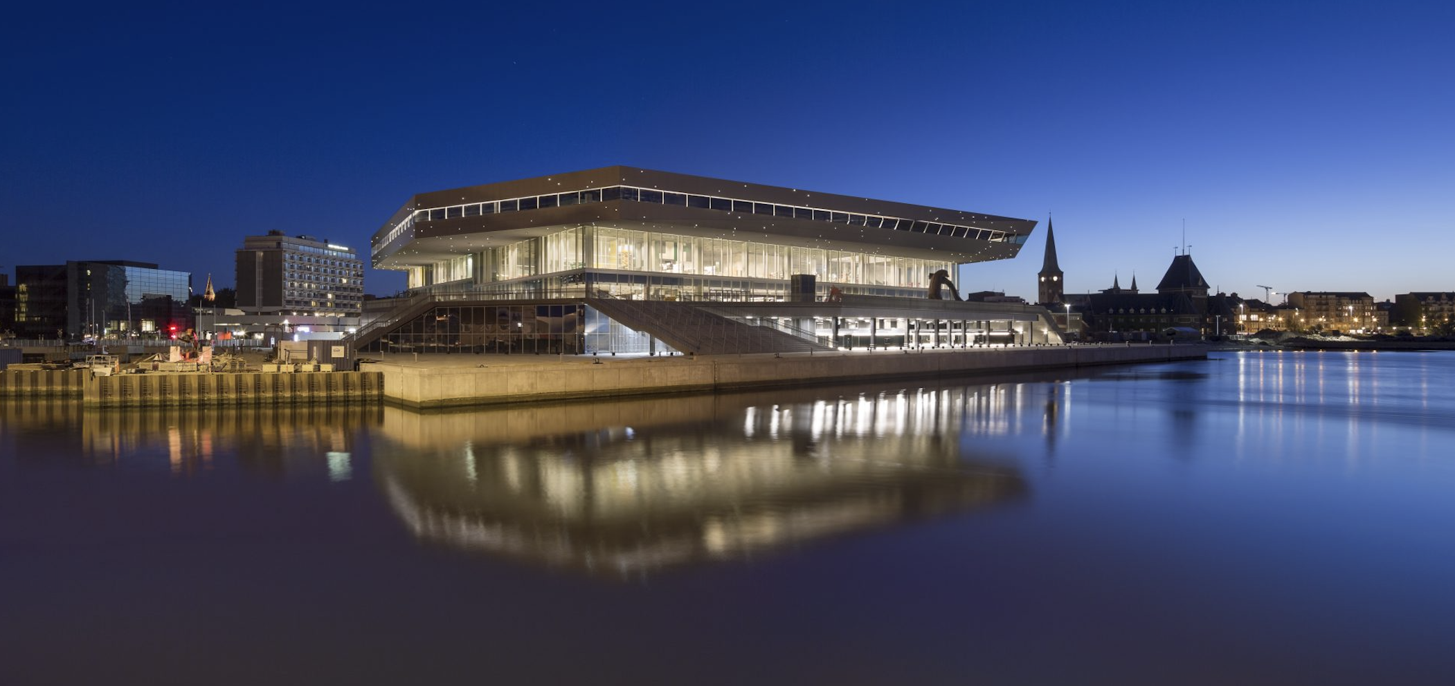 The Dokk1 building lit up at night